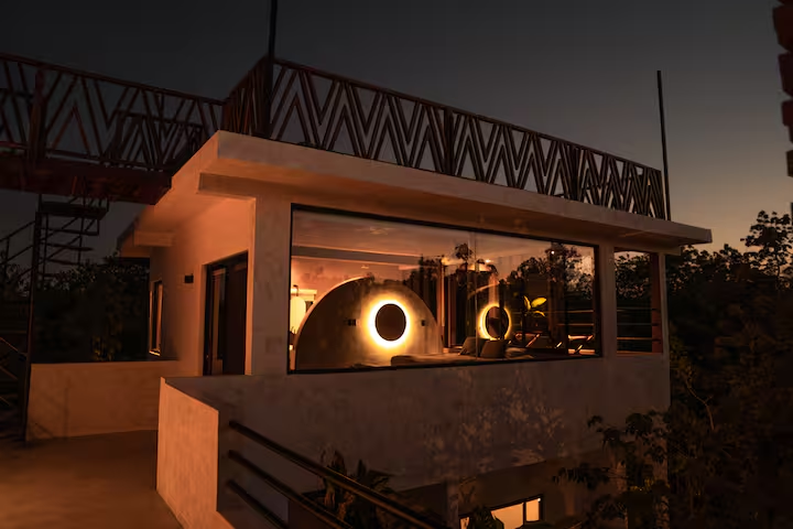 Revivis Suite — exterior at dusk with glowing arch