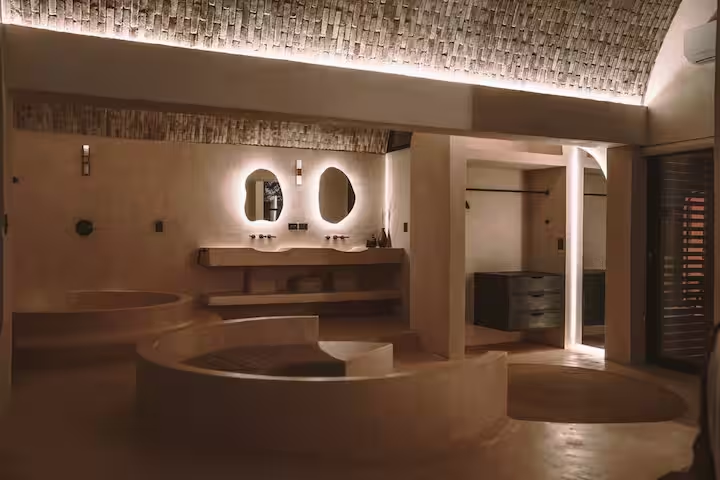 Maya Suite — vaulted bathroom at dusk with mood lighting