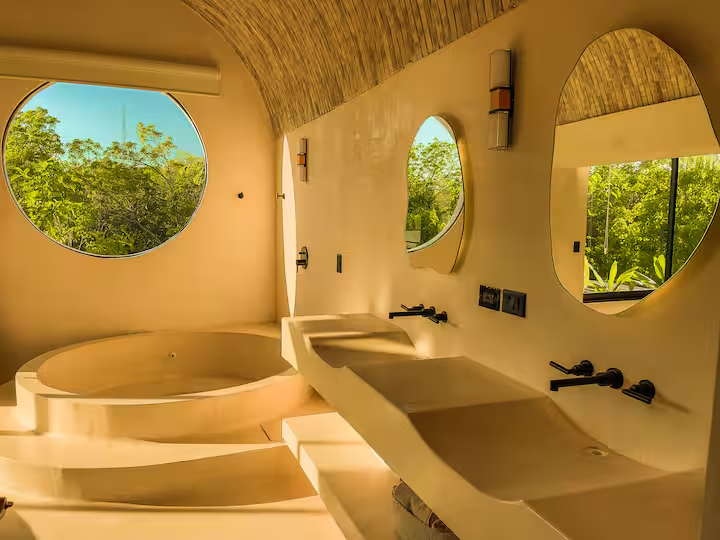 Maya Suite — double-sink en-suite with organic mirrors