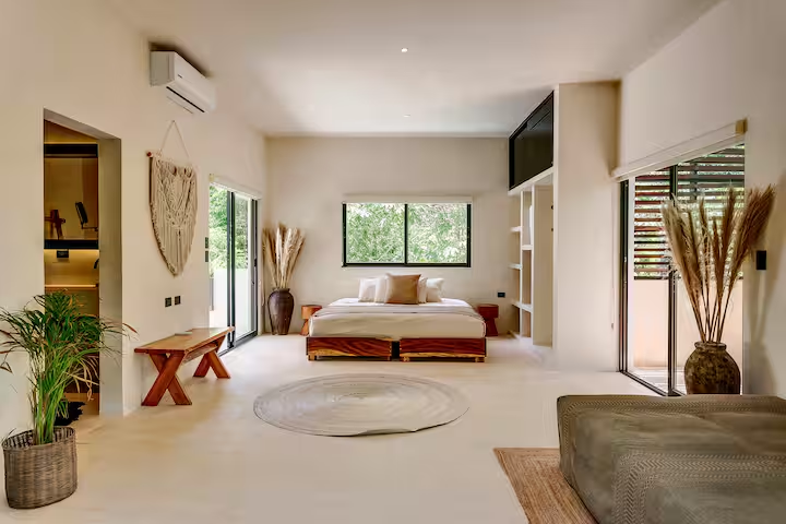 Cajmere Suite — open room with bench seating and twin balcony doors