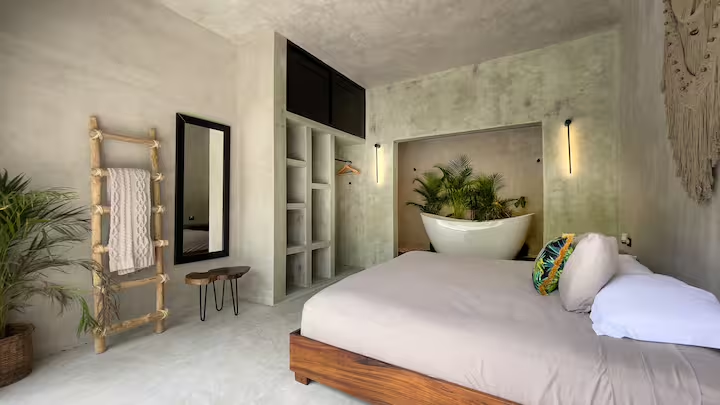 Tirzah Suite — king bed with tub alcove and macramé wall hanging