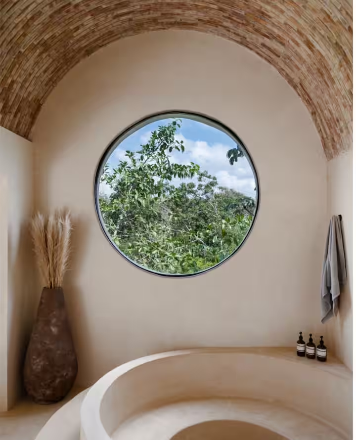 Maya Suite — soaking tub with round jungle window