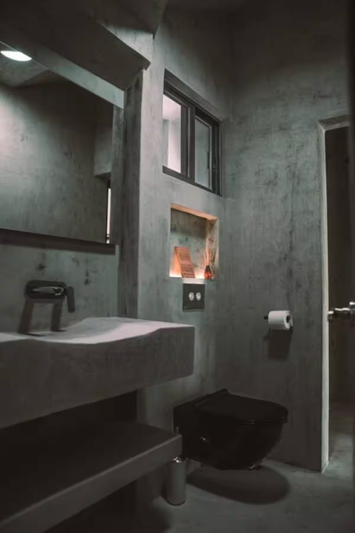 Ferro Suite — concrete en-suite bathroom with floating sink and black fixtures